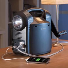 an old fashioned radio sitting on top of a table next to a lamp and charger