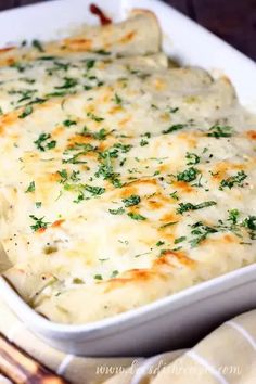 a casserole dish with cheese and herbs