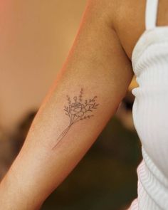 a woman with a flower tattoo on her arm