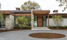 a modern house with stone and wood accents