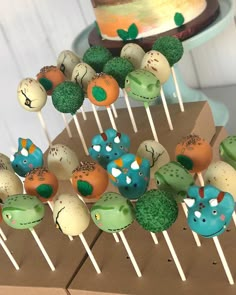 there are many cake pops with animals on them in the shape of plants and birds