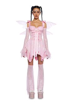 a woman in pink dress and boots with wings on her head, standing against a white background