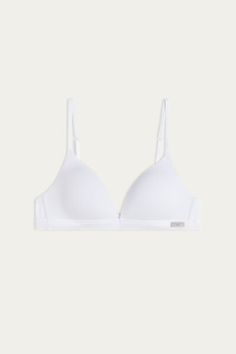 Tiziana triangle bra in cotton with lightly padded cups. Wireless cups with side boning and cotton lining. A hook on the strap adjusters allows you to cross the straps in the back to create a racerback fit, or to hide them for certain necklines. Created for those looking for simple, practical styles. This item runs small. White Low-cut Bra With Adjustable Straps, White Spaghetti Strap Bra With Adjustable Straps, Classic Push-up Bra With Adjustable Straps, Triangle Bra, A Hook, Lingerie Collection, Bra Women, Clothes Collection, Sports Bra