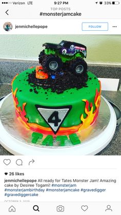 a monster truck cake on top of a white plate with green frosting and flames