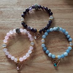 "Handmade beaded bracelet with a golden \"Mom\" charm in three color options. A perfect gift for Mothers' Day, birthdays, or Christmas! Made from rose quartz, amethyst, or aquamarine; all with selenite accents."