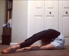 a woman is doing yoga on the floor in front of a bookcase and door