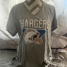 a gray shirt with an image of a football helmet on it