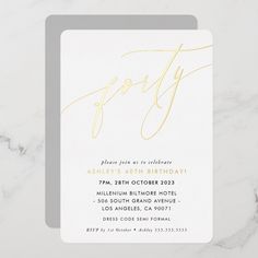 a white and gold party card on a marble surface