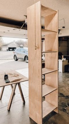 an open bookcase sitting in the middle of a garage