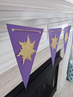 a purple and gold banner hanging from a fireplace