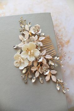 a hair comb with flowers and leaves on it