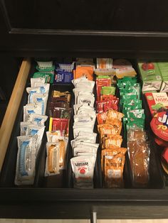 a drawer filled with lots of different types of food and snacks on top of it