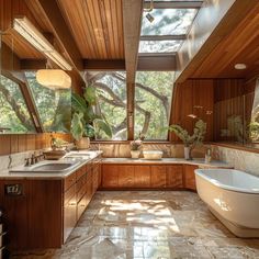 a bathroom with a large bathtub and sink under a skylight in the corner