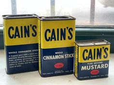 three tin cans sitting on top of a table