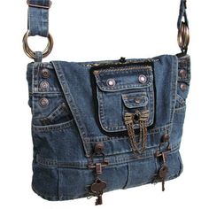 a denim purse with chains hanging from it's front and shoulder straps on the side