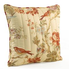 a decorative pillow with birds and flowers on the front, sitting on a white background