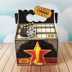 an open box with a star on the side and a movie reel attached to it