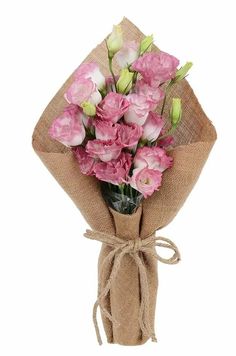 a bouquet of pink flowers wrapped in burlock