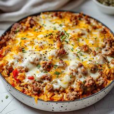 a casserole dish filled with meat and cheese