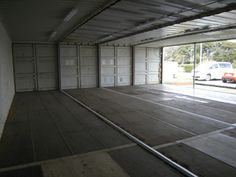 an empty garage with two cars parked in it