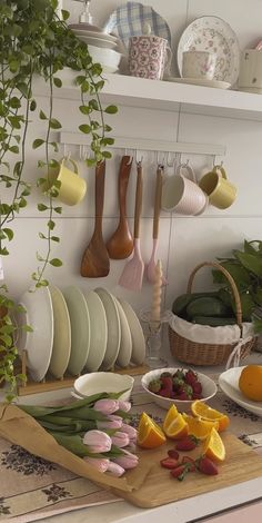 a kitchen counter with plates, bowls and utensils