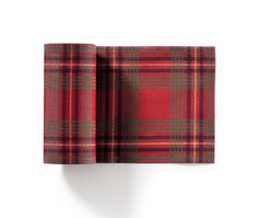 a red and green plaid cloth hanging on a wall