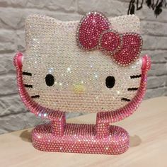 a hello kitty figurine made out of swaro - bead and sequins