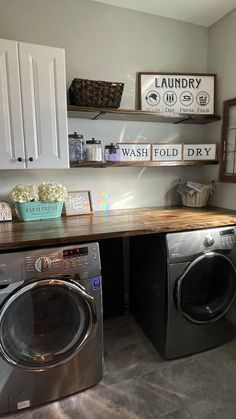 a washer and dryer in a laundry room with shelves above the washer