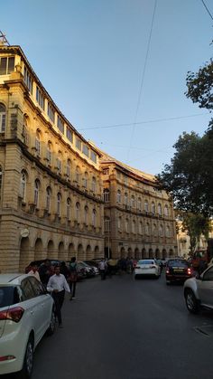 cars are parked in front of an old building