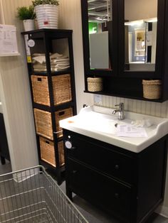 a bathroom with a sink, mirror and shelving unit