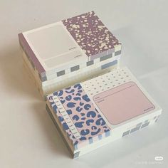 two boxes are stacked on top of each other with different patterns and colors in them