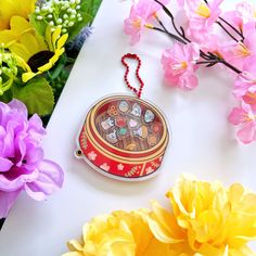 an ornament on a table surrounded by flowers