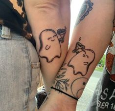 two people holding hands with tattoos on their arms, one has an elephant and the other has a dog