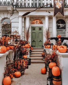 a house with pumpkins and decorations on the front porch