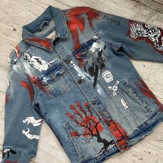 an old jean jacket that has been painted with different designs