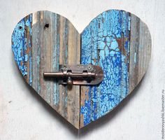 a heart shaped wooden object with a lock on the front and back side, painted blue