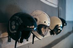 helmets are lined up on the wall to be worn by motorcyclists or bikers