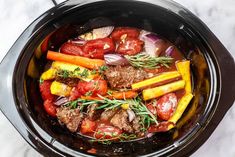 a slow cooker filled with meat and vegetables