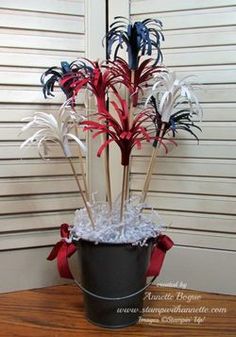 a potted plant with red, white and blue flowers