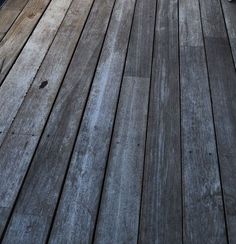 a skateboarder is riding down a wooden deck