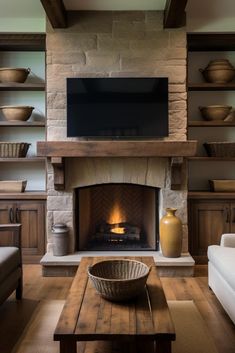 a living room filled with furniture and a fire place in front of a flat screen tv