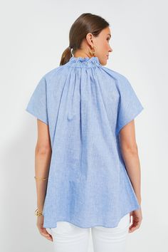 Effortlessly chic, the Rae Blouse takes everything we love about a classic button down and elevates it with fun, feminine details. Featuring a high neck ruffle collar, short cap sleeves, a button front placket, and a simple yet chic chambray fabric, this blue shirt pairs well with denim and flats for daytime and gold jewelry for dining out with friends. Ruffle collar Short cap sleeves Button front placket Gathered back Relaxed fit Chambray fabric Material: 70% Cotton, 30% Linen Care: Hand wash c Neck Ruffle Collar, Chambray Fabric, Feminine Details, Plus And Minus, Ruffle Collar, Neck Ruffle, Blue Shirt, Denim Shop, Fabric Material