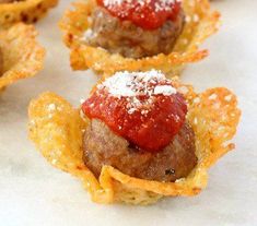 mini meatballs with ketchup and potato chips on a white tablecloth background