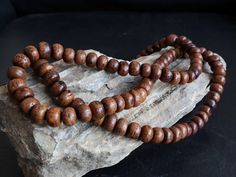 Natural 108 beads Bodhi Seed mala prayer beads from Nepal. Here's why it's a must-have for your spiritual practice: Sacred Bodhi Seeds: Known as the seeds of enlightenment, each of the 108 beads (10 mm size) is a symbol of knowledge and spiritual growth. Handcrafted Quality: Lovingly hand-strung, this mala boasts authenticity and the unique touch of Nepalese craftsmanship. Versatile Use: Ideal for counting mantras, prayers, and other spiritual practices. Enhance your meditation with the resonant Traditional Round Wooden Beads, Festival Wooden Beaded Bracelets, Traditional Round Wooden Beaded Bracelets, 8mm Round Beads For Festivals, Rope Incense, Buddha Bracelet Beads, Beads Mala, Buddha Beads, Bracelets Handmade Diy