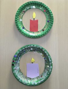 two paper plates with candles on them are sitting on a table