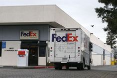 a fed ex truck parked in front of a building