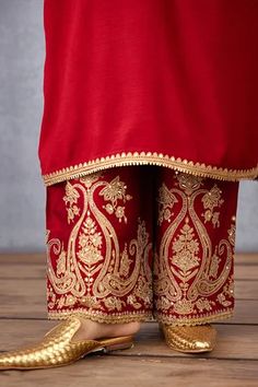 Red straight kurta with contrast hand embroidery on the neckline and sleeve hems. Comes with wide legged pants and silk organza dupatta. Component: 3 Pattern: Embroidery Type Of Work: Dori and Adda Work Neckline: Notch Sleeve Type: Full Fabric: Raw Silk, Cotton Voile and Silk Organza Color: Red Other Details:  Dupatta with embroidered cutwork border Side slits Pant with embroidery on the hems Occasion: Wedding - Aza Fashions Raw Silk Embroidery, Kurta Set For Women, Embroidery On Kurtis, Kurti Embroidery Design, Batik Fashion, Hand Work Embroidery, Fashion Design Dress, Embroidery Suits Design