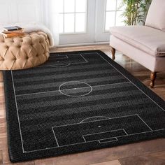 a black rug with a soccer field on it in front of a couch and chair