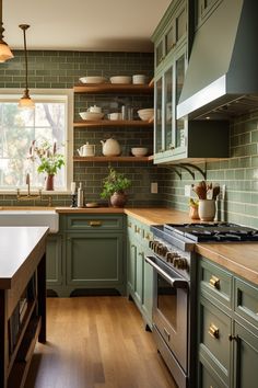 a kitchen with green cabinets and wooden floors