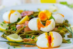 a white plate topped with green beans and hard boiled eggs